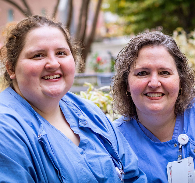 Benefits_Photo healthcare workers wearing blue scrubs outside hospital