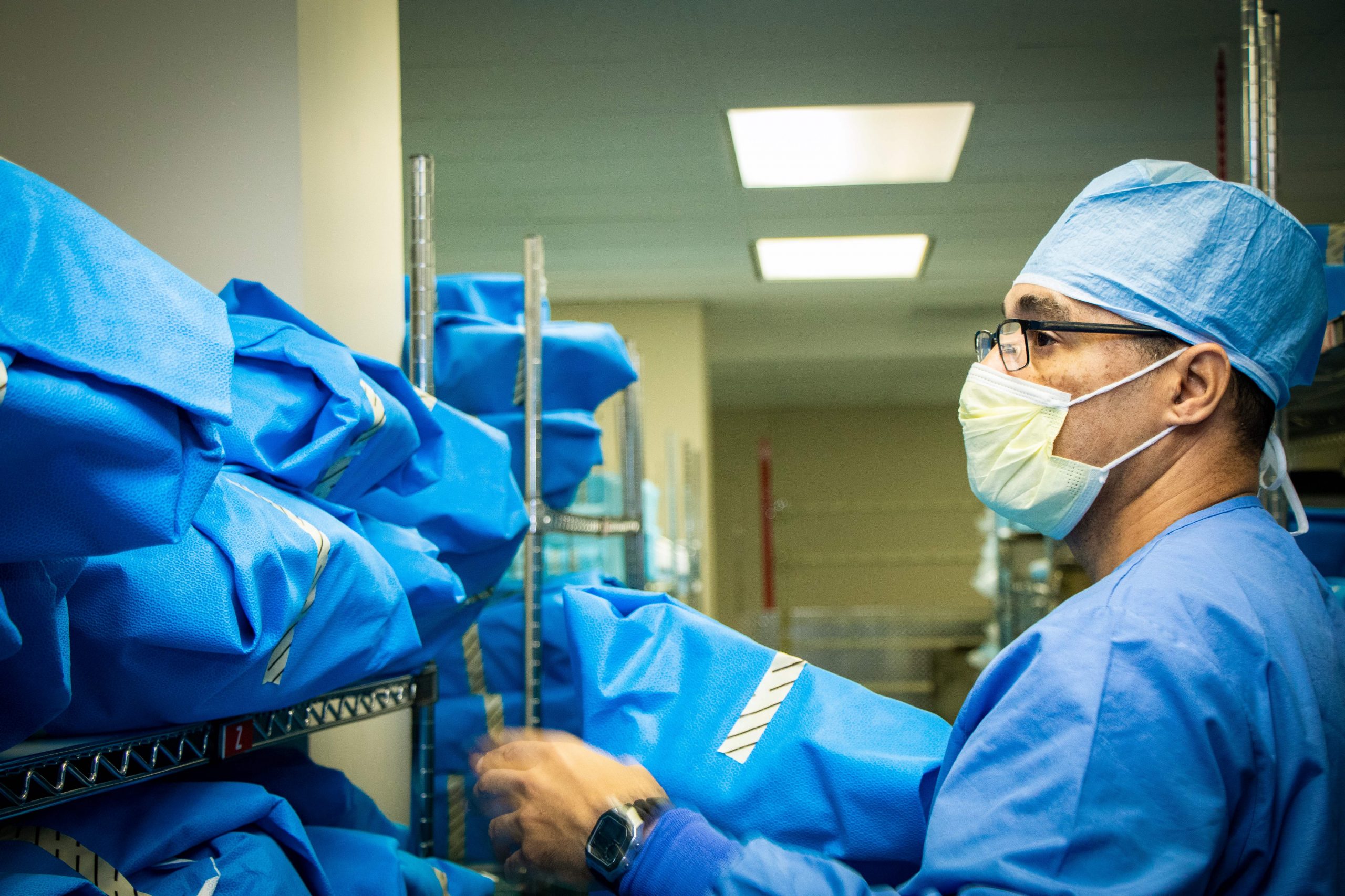 Man organizes surgical equipment.