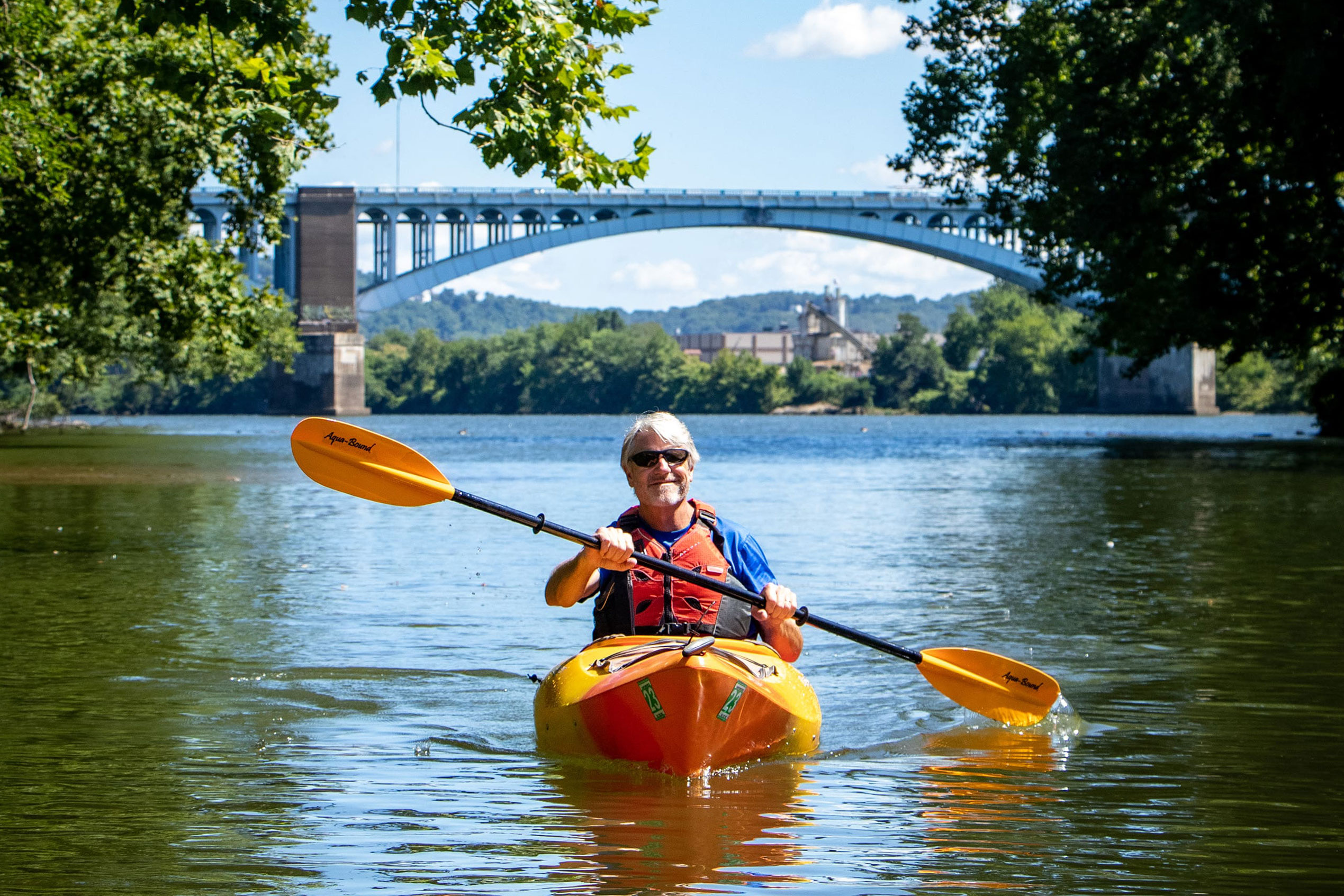 Man on kayak on Pittsburgh river.