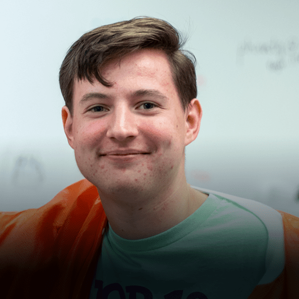 Young man stands in lab environment.
