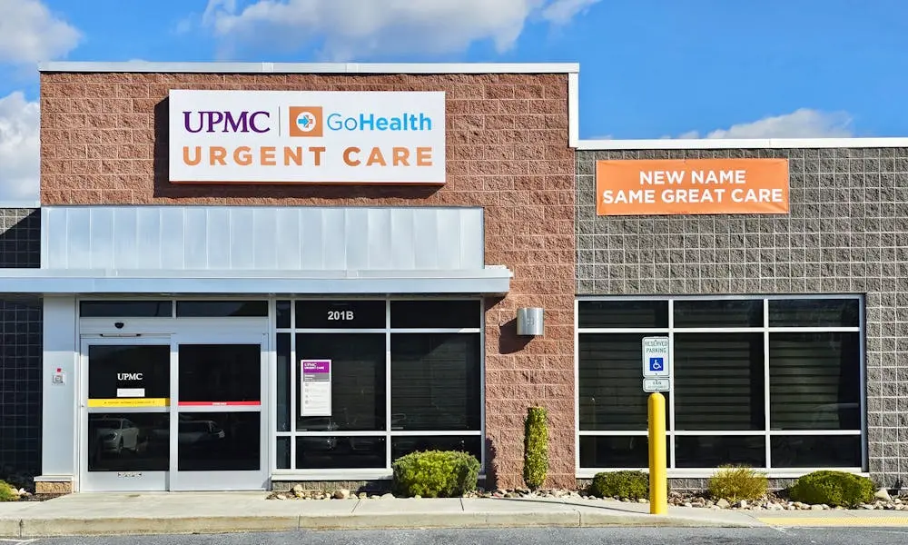 Brick building with sign reading UPMC-Go Health Urgent Care.